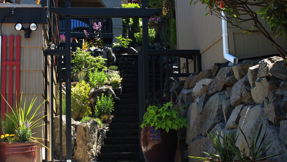 Photo of a large transitional partial sun backyard stone formal garden in Seattle for summer.