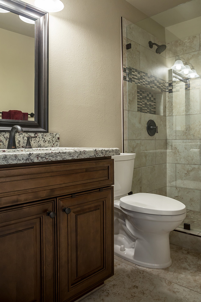 Mid-sized transitional kids' beige tile and porcelain tile porcelain tile and beige floor alcove shower photo in Phoenix with shaker cabinets, dark wood cabinets, a two-piece toilet, beige walls, an undermount sink, granite countertops and a hinged shower door