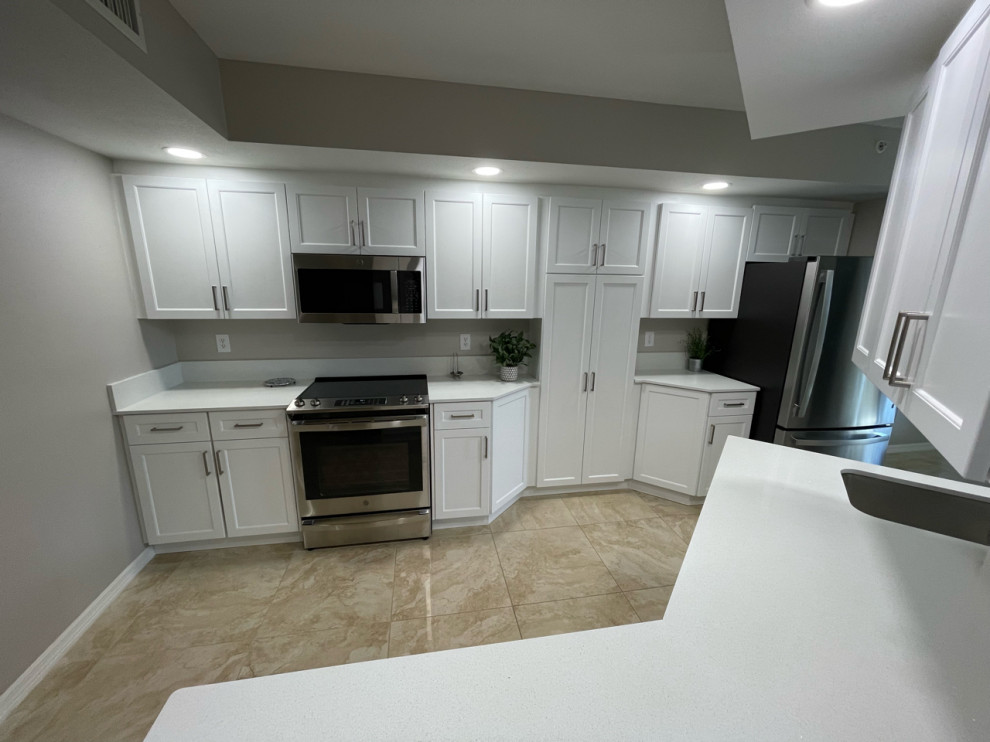 Large transitional eat-in kitchen in Tampa with shaker cabinets, white cabinets, quartz benchtops and white benchtop.