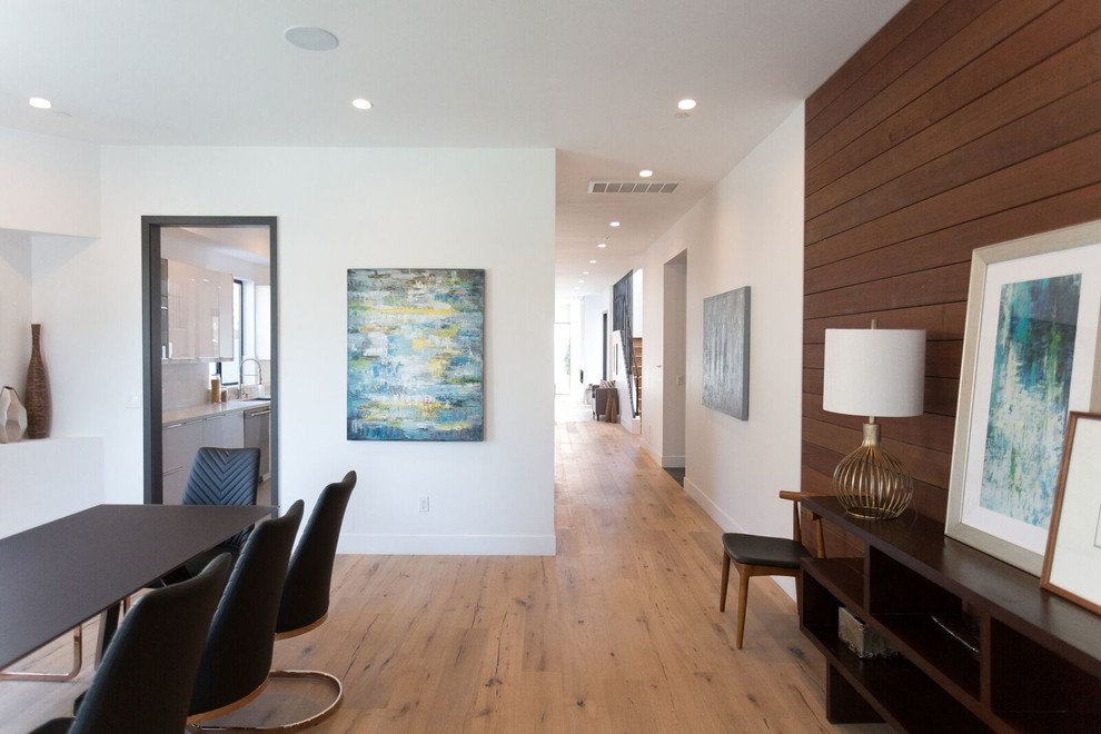 Enclosed dining room - mid-sized transitional light wood floor enclosed dining room idea in Orange County with white walls and no fireplace