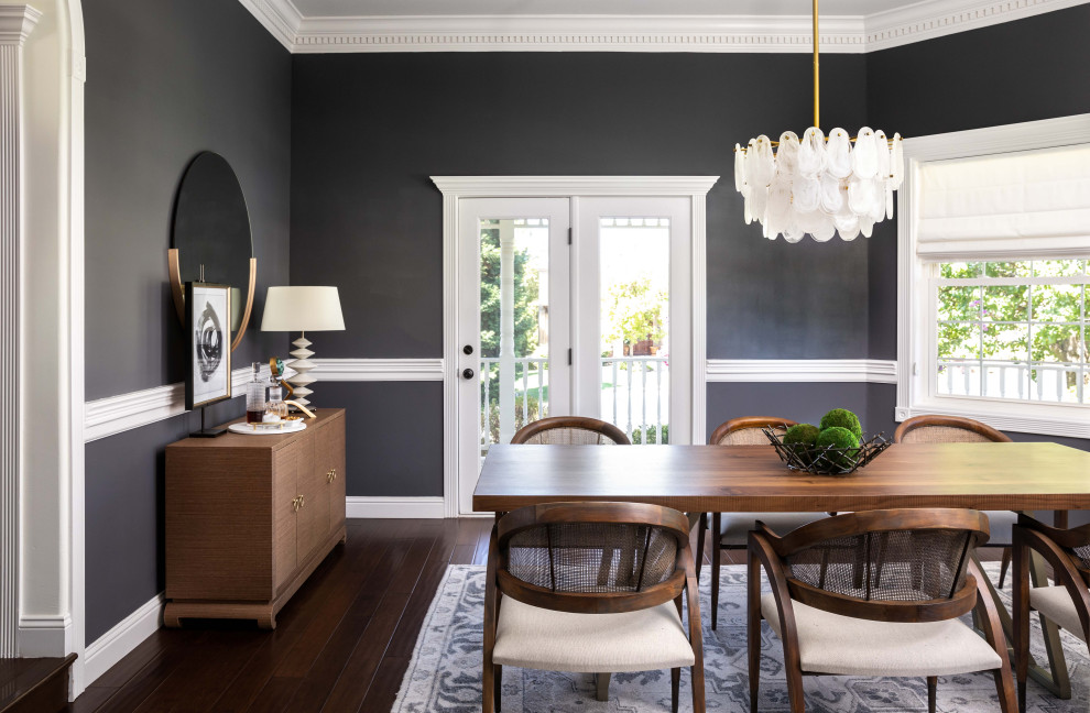 Inspiration for a mid-sized transitional separate dining room in Sacramento with black walls, dark hardwood floors, no fireplace and brown floor.