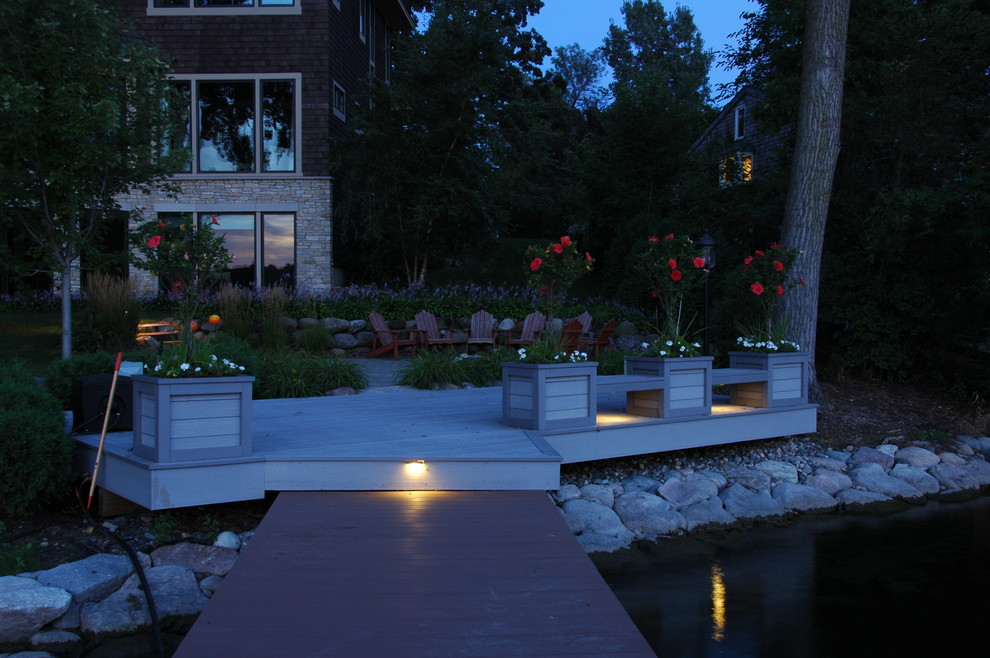 Example of a mid-sized transitional backyard dock design in Minneapolis with no cover
