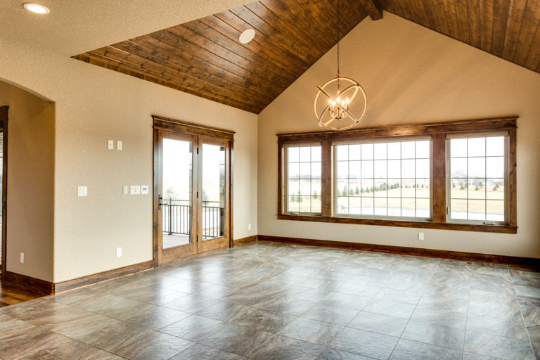 Example of a large mountain style kitchen/dining room combo design with beige walls