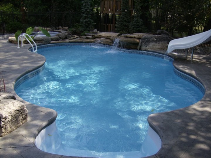 Large backyard stone pool photo in Toronto