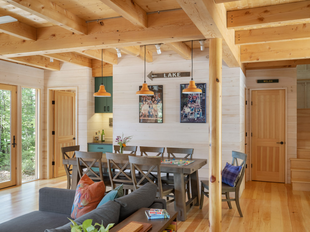 Idee per una sala da pranzo rustica con pareti beige, pavimento in legno massello medio, pavimento marrone, travi a vista e pareti in legno
