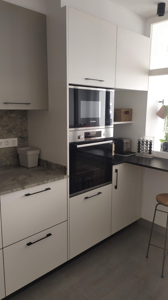 Medium sized urban grey and pink single-wall enclosed kitchen in Other with a belfast sink, flat-panel cabinets, white cabinets, granite worktops, grey splashback, granite splashback, stainless steel appliances, ceramic flooring, no island, grey floors and grey worktops.