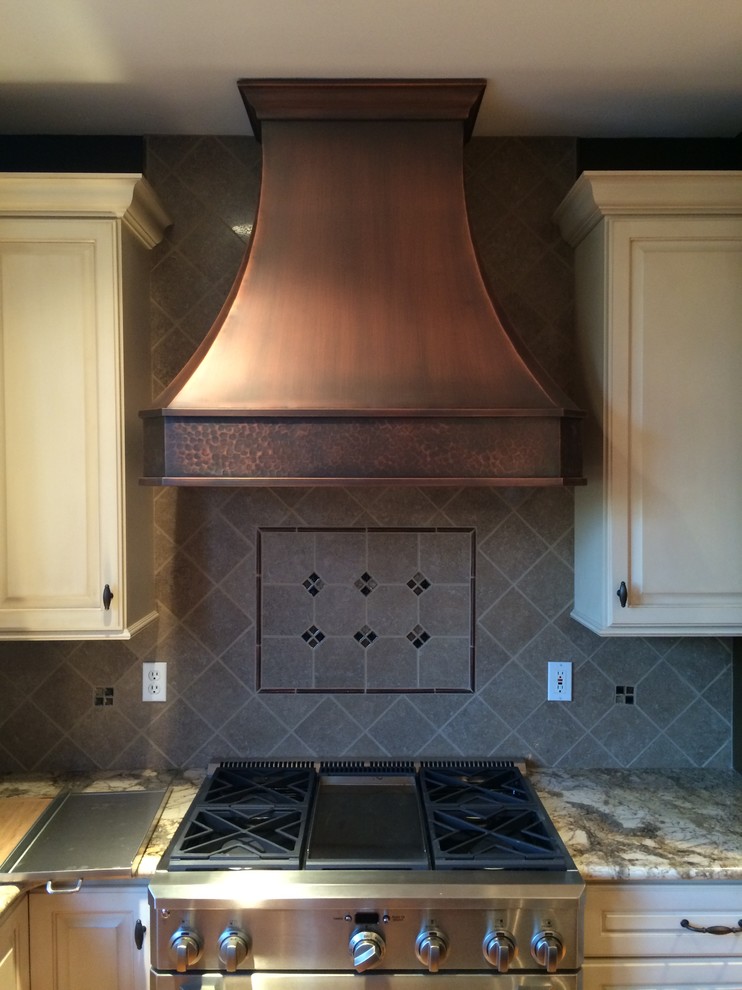 Inspiration for a transitional l-shaped medium tone wood floor kitchen remodel in St Louis with a farmhouse sink, raised-panel cabinets, granite countertops and an island