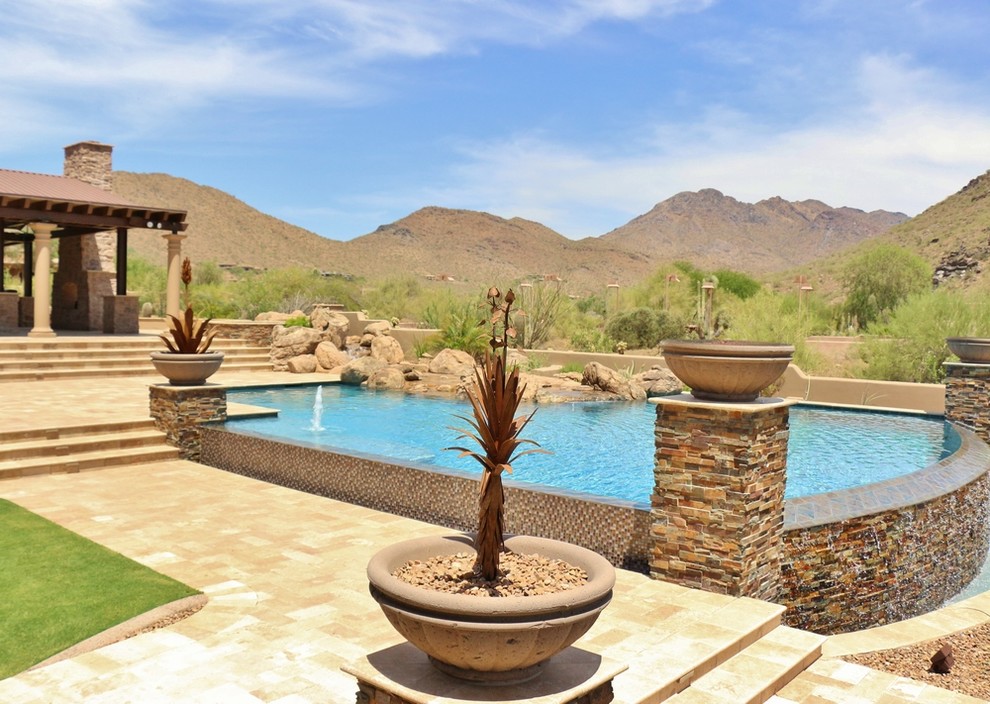 Inspiration for a large backyard concrete paver and custom-shaped infinity pool fountain remodel in Phoenix