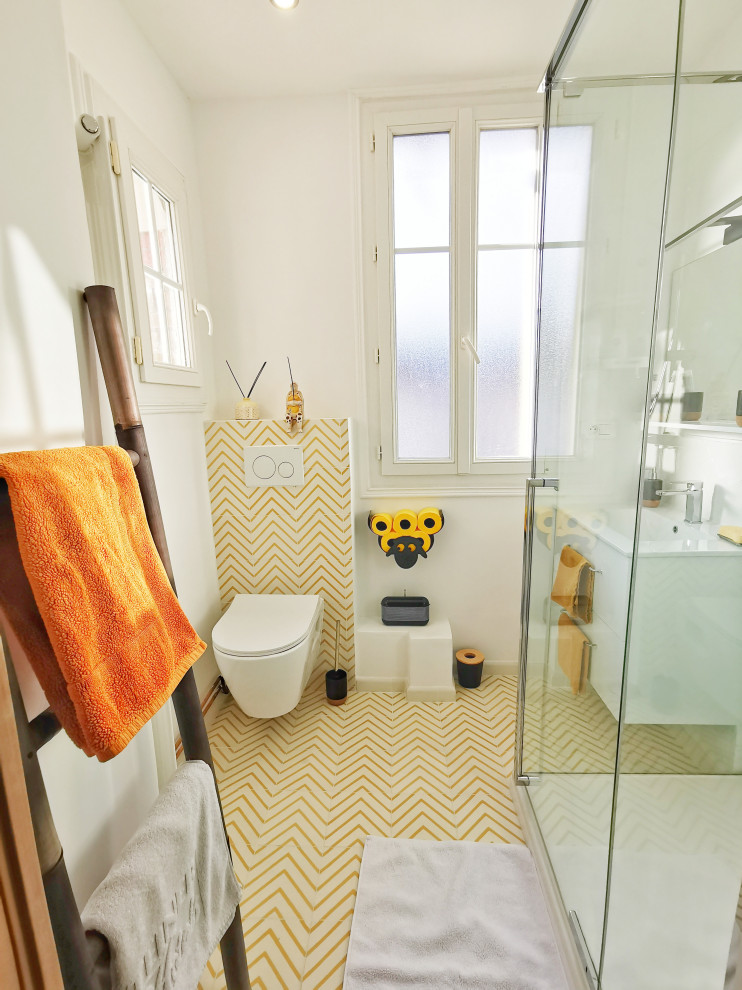 На фото: маленькая ванная комната в современном стиле с плоскими фасадами, белыми фасадами, двойным душем, инсталляцией, белой плиткой, керамической плиткой, белыми стенами, полом из цементной плитки, душевой кабиной, врезной раковиной, желтым полом, душем с распашными дверями, белой столешницей, тумбой под одну раковину и подвесной тумбой для на участке и в саду с