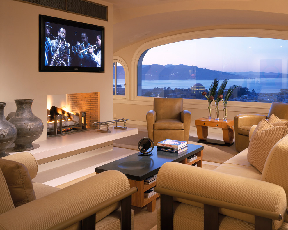 This is an example of a contemporary living room in San Francisco with a two-sided fireplace and a wall-mounted tv.