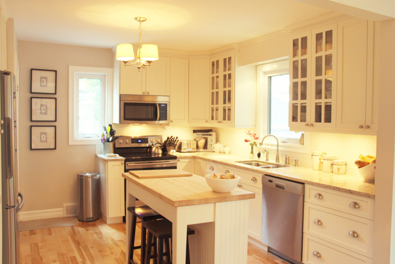 Inspiration for a large u-shaped light wood floor kitchen remodel with a drop-in sink, white cabinets, granite countertops, stainless steel appliances and an island