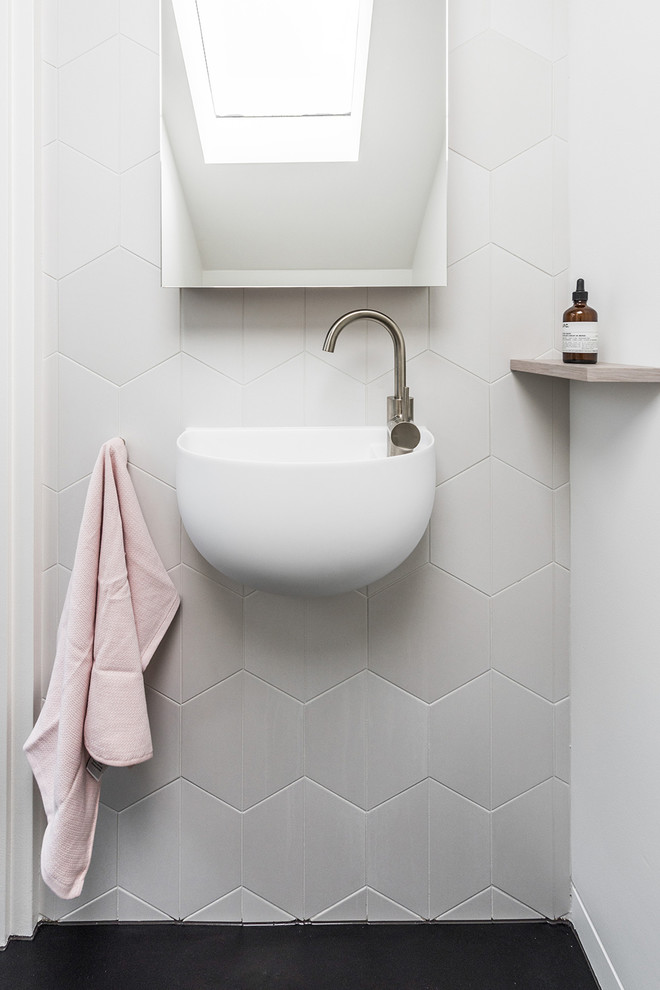 Inspiration for a small contemporary 3/4 bathroom in Melbourne with flat-panel cabinets, light wood cabinets, an open shower, a one-piece toilet, white tile, porcelain tile, white walls, engineered quartz benchtops, an open shower, dark hardwood floors, a wall-mount sink and black floor.