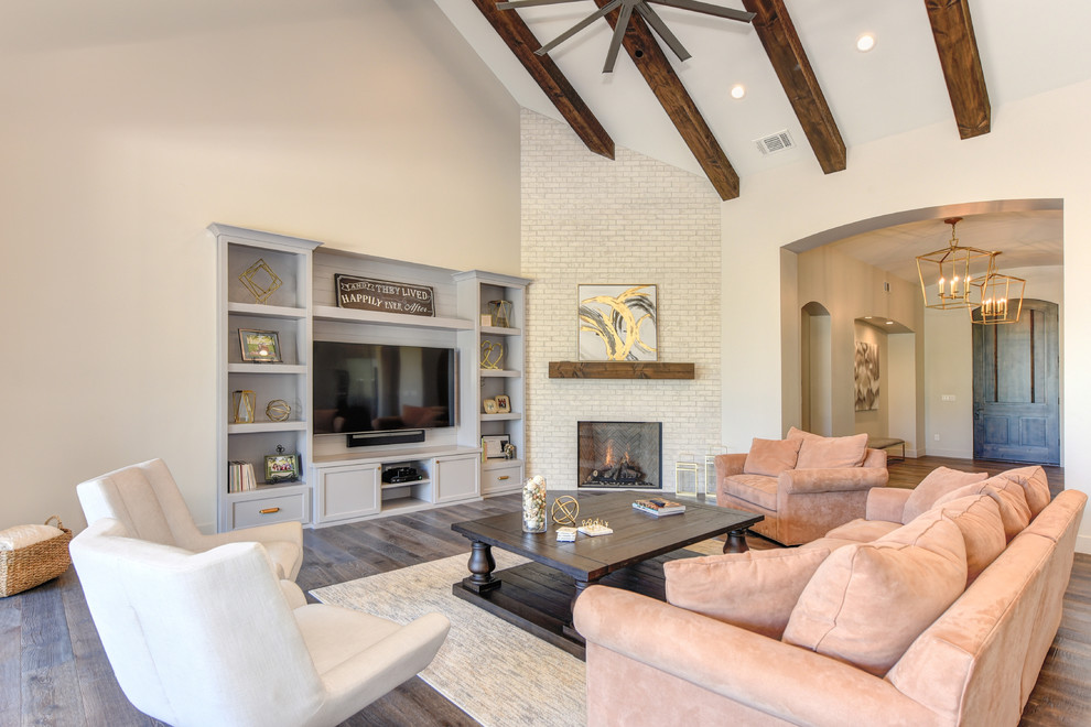 Open concept family room in Sacramento with white walls, medium hardwood floors, a corner fireplace, a brick fireplace surround, a built-in media wall and brown floor.