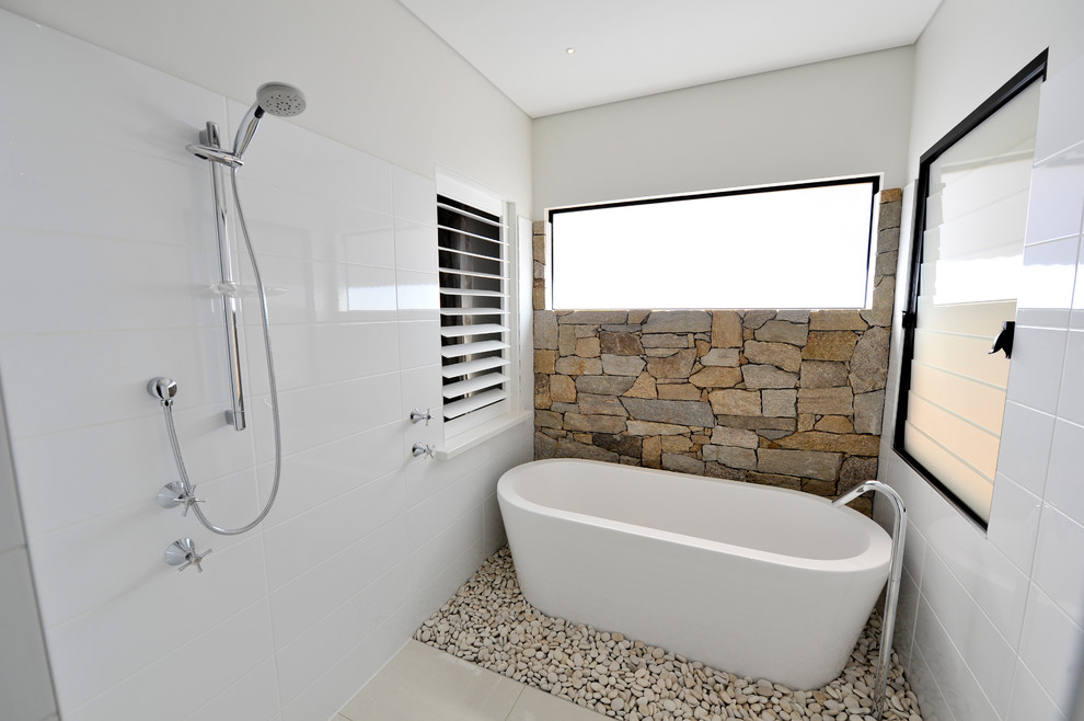 Mid-sized contemporary master bathroom in Dunedin with a freestanding tub, an open shower, white tile, ceramic tile, white walls and porcelain floors.