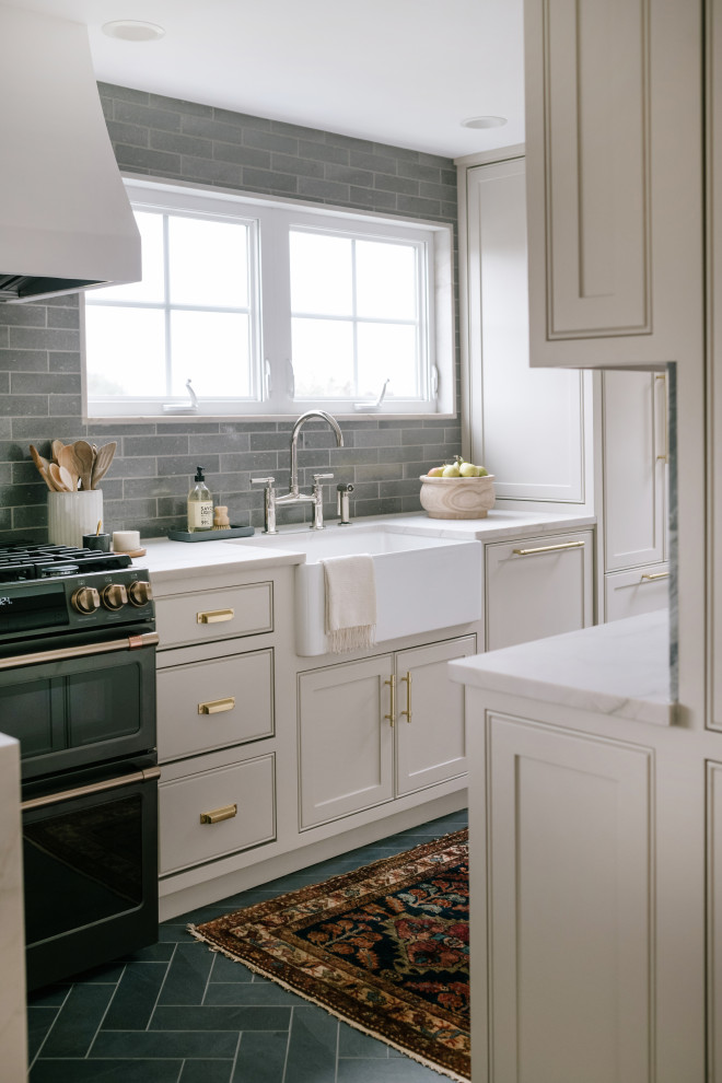 Small elegant l-shaped porcelain tile and gray floor eat-in kitchen photo in Seattle with a farmhouse sink, beaded inset cabinets, gray cabinets, quartz countertops, green backsplash, ceramic backsplash, black appliances, a peninsula and white countertops