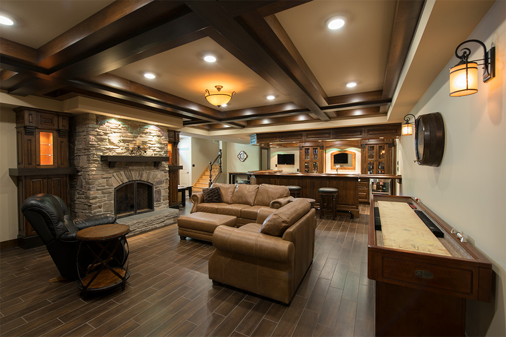Photo of a large traditional fully buried basement in Ottawa with beige walls, ceramic floors, a standard fireplace and a stone fireplace surround.