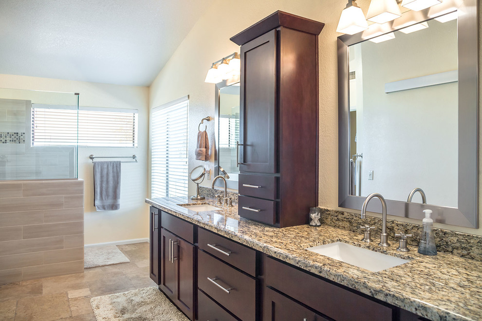 Inspiration for a large transitional master brown tile and porcelain tile ceramic tile walk-in shower remodel in Phoenix with recessed-panel cabinets, dark wood cabinets, a two-piece toilet, beige walls, an undermount sink and granite countertops