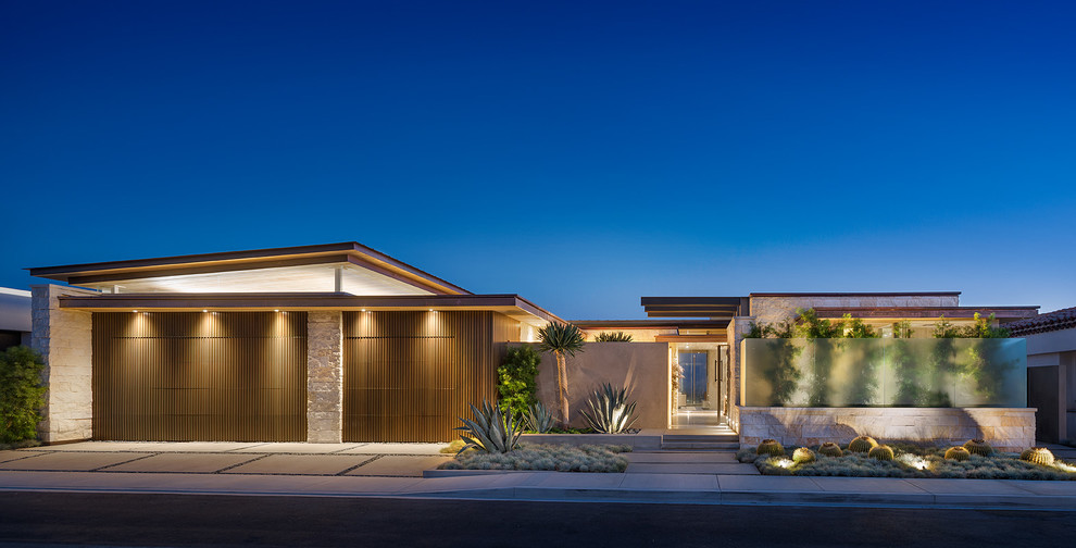 This is an example of a contemporary one-storey exterior in Los Angeles with stone veneer and a shed roof.