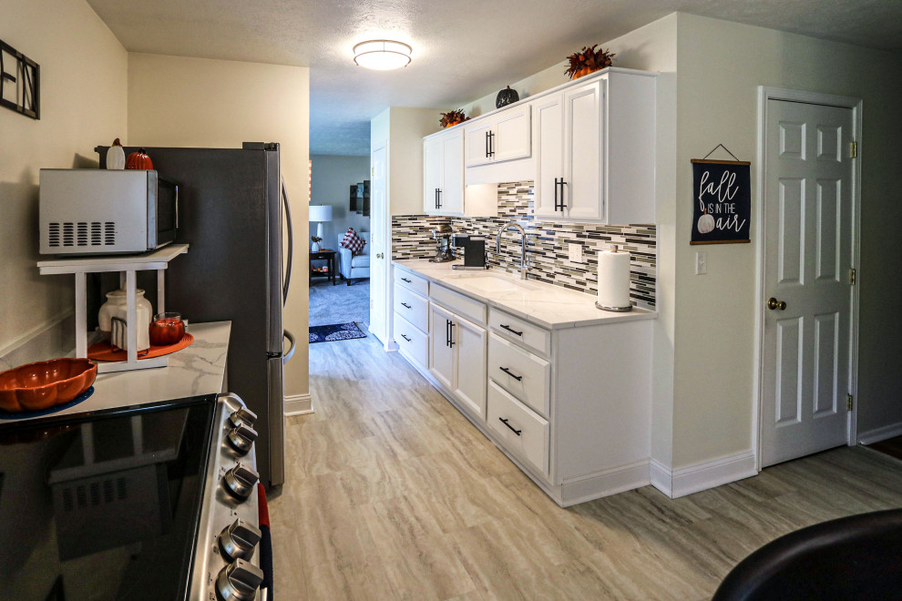 White Kitchen with Quartz Countertop and Mosaic Tile Backsplash ...