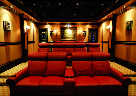 Inspiration for a large enclosed home theatre in Tampa with red walls, carpet and a projector screen.