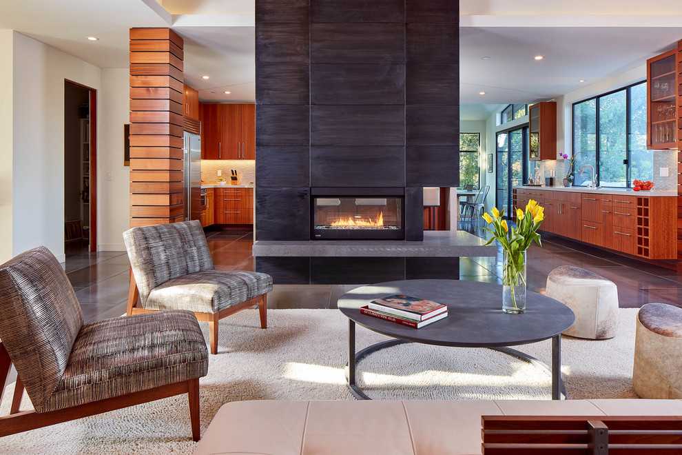 This is an example of a contemporary family room in San Francisco with white walls and a two-sided fireplace.