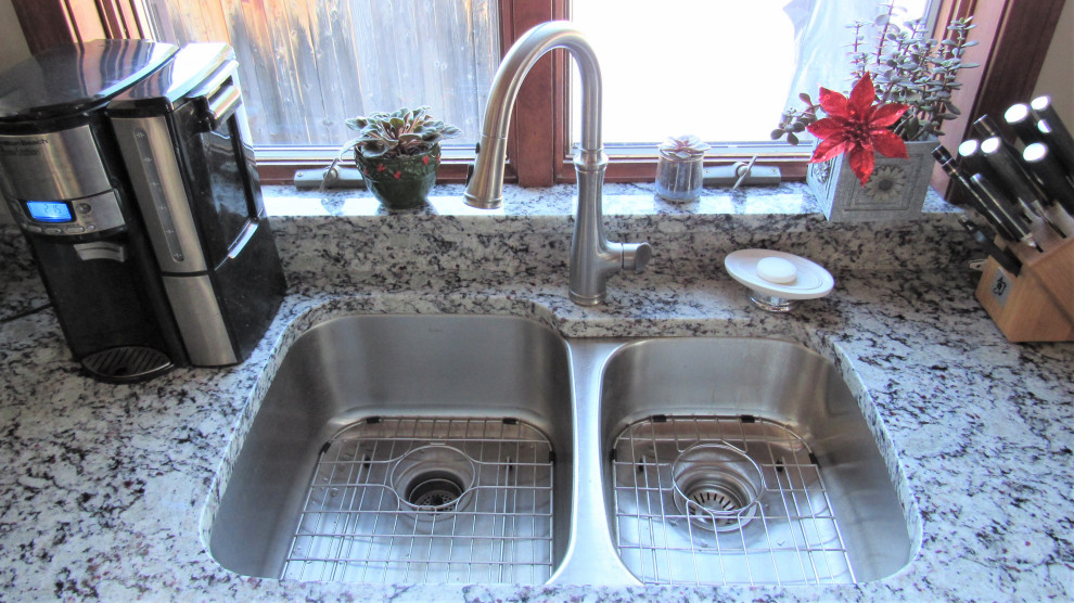 Inspiration for a mid-sized transitional u-shaped eat-in kitchen remodel in Boston with an undermount sink, shaker cabinets, beige cabinets, granite countertops, stainless steel appliances, a peninsula and gray countertops