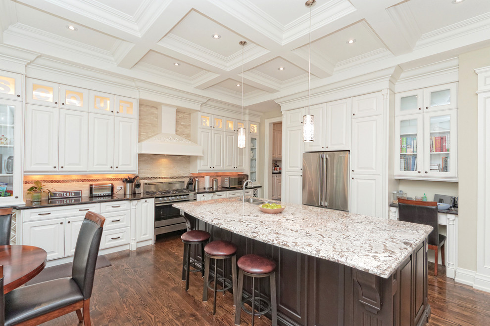 Large transitional single-wall dark wood floor and brown floor kitchen photo in Toronto with a double-bowl sink, raised-panel cabinets, white cabinets, granite countertops, beige backsplash, stainless steel appliances and an island