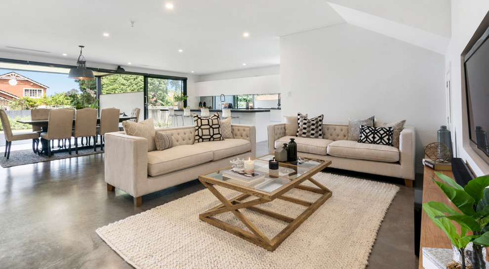Photo of a mid-sized contemporary open concept living room in Sydney with white walls, concrete floors, a built-in media wall and grey floor.