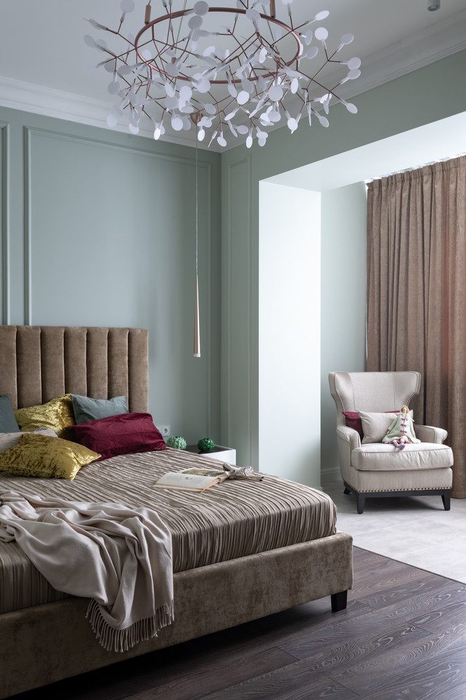 Photo of a transitional bedroom in Moscow with green walls, dark hardwood floors and brown floor.