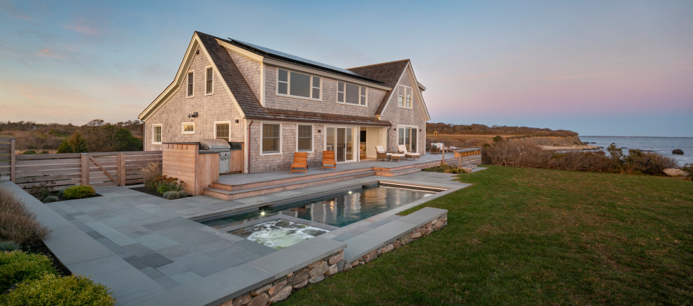 Photo of a mid-sized beach style two-storey grey house exterior in Providence with wood siding, a shingle roof and shingle siding.
