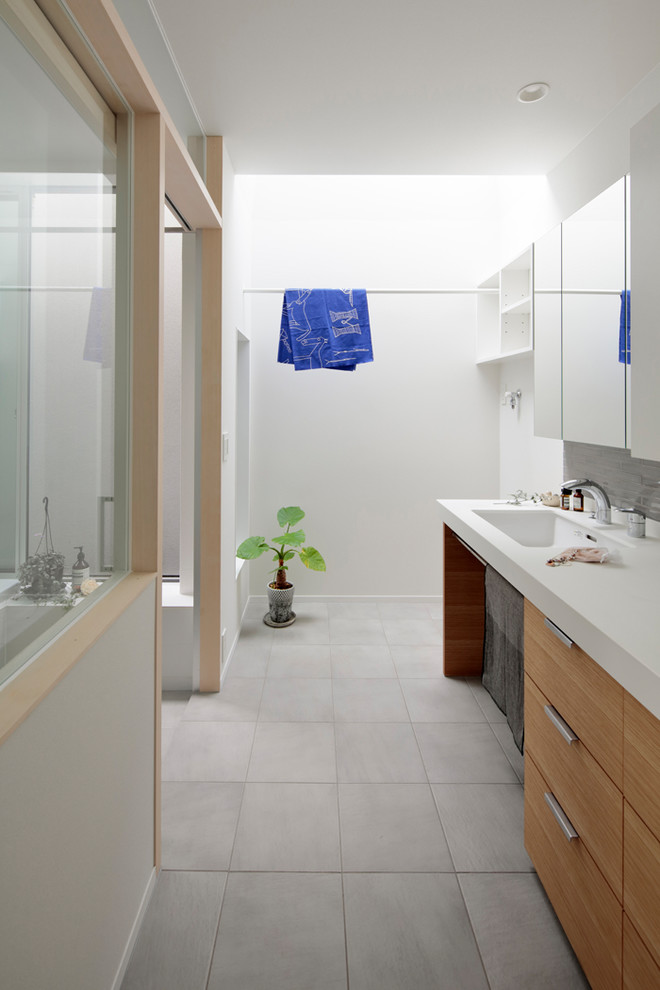 This is an example of a modern laundry room in Other.