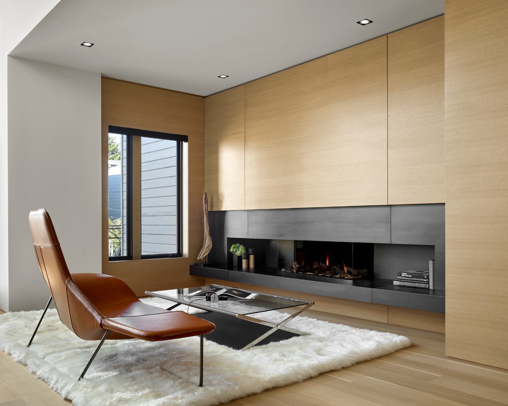 Contemporary living room in San Francisco with white walls, medium hardwood floors and a ribbon fireplace.