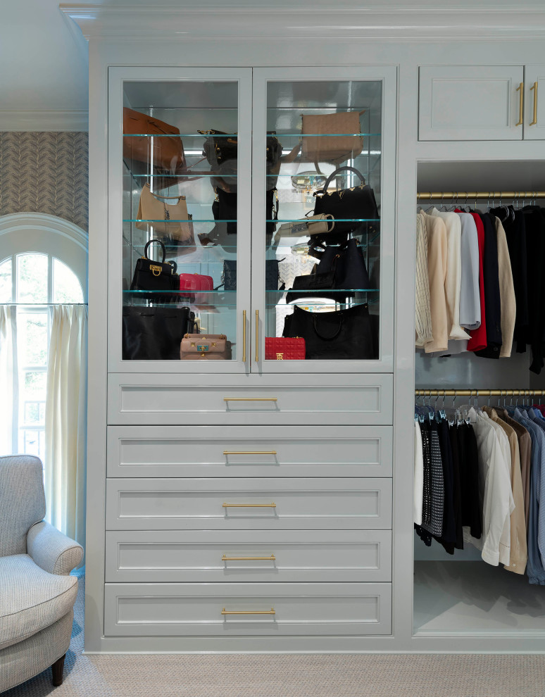 This is an example of a mid-sized transitional women's walk-in wardrobe in Dallas with beaded inset cabinets, grey cabinets, carpet and grey floor.