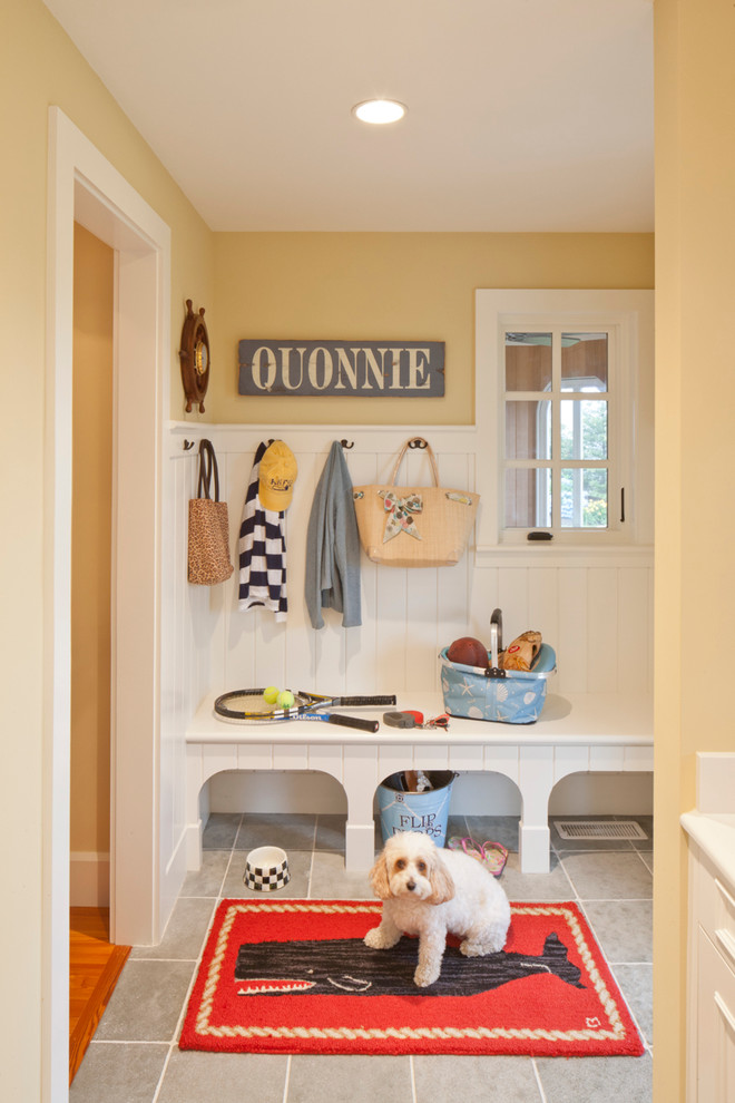 Mid-sized beach style mudroom in Boston with yellow walls, ceramic floors and grey floor.