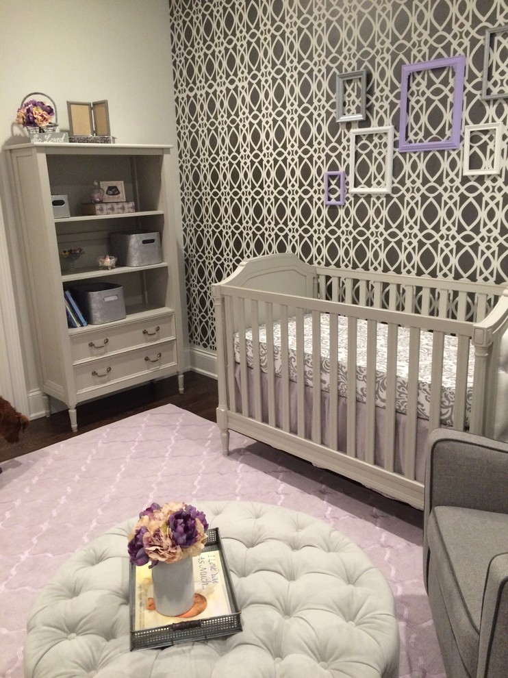 Photo of a mid-sized traditional nursery for girls in Chicago with grey walls and dark hardwood floors.