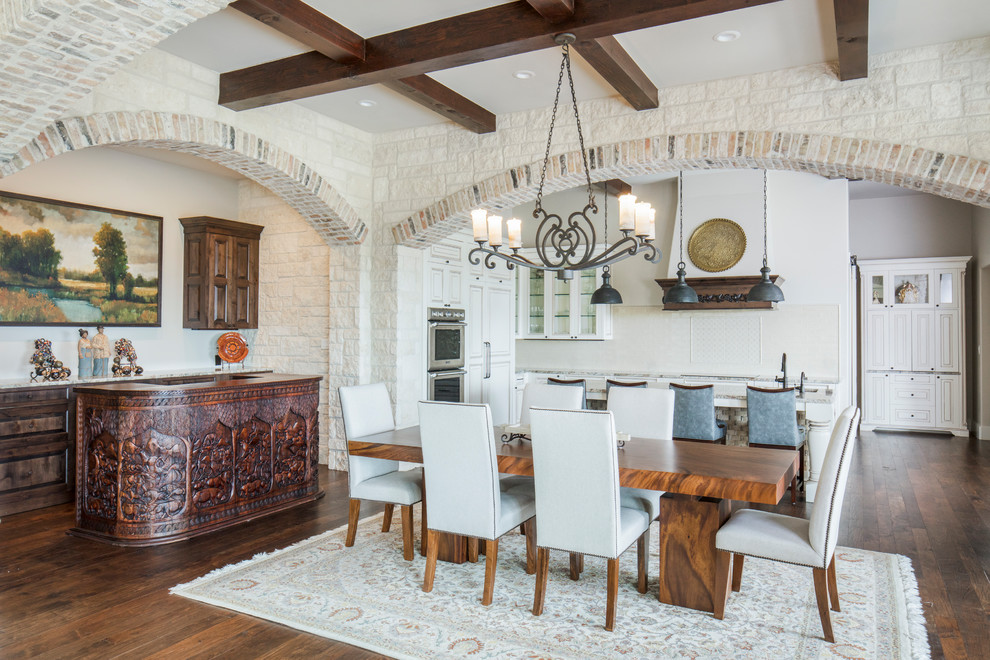 This is an example of a mediterranean dining room in Austin with no fireplace and medium hardwood floors.