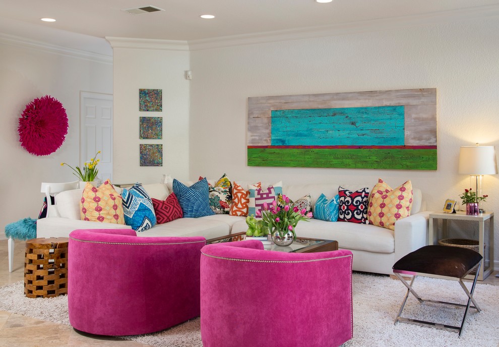 This is an example of a mid-sized beach style open concept family room in San Diego with white walls, travertine floors, a standard fireplace, a wall-mounted tv and grey floor.