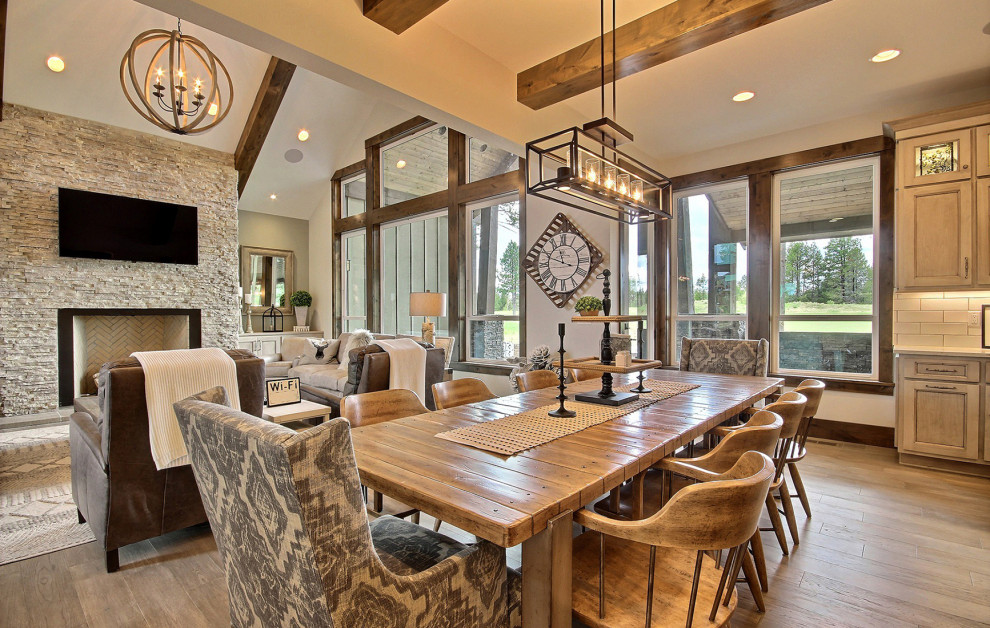 Design ideas for an expansive classic kitchen/dining room in Portland with beige walls, dark hardwood flooring, a standard fireplace, a stone fireplace surround, brown floors and exposed beams.