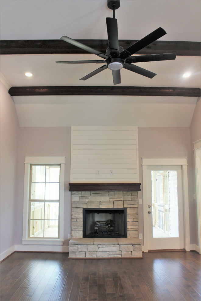Example of a mid-sized classic open concept brown floor and exposed beam family room design in Birmingham with gray walls