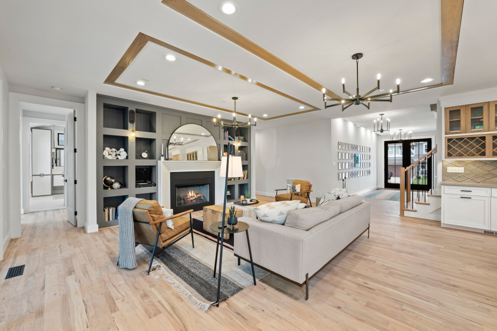 Inspiration for a large contemporary open plan games room in Richmond with white walls, light hardwood flooring, a standard fireplace, a plastered fireplace surround, no tv, beige floors and a drop ceiling.