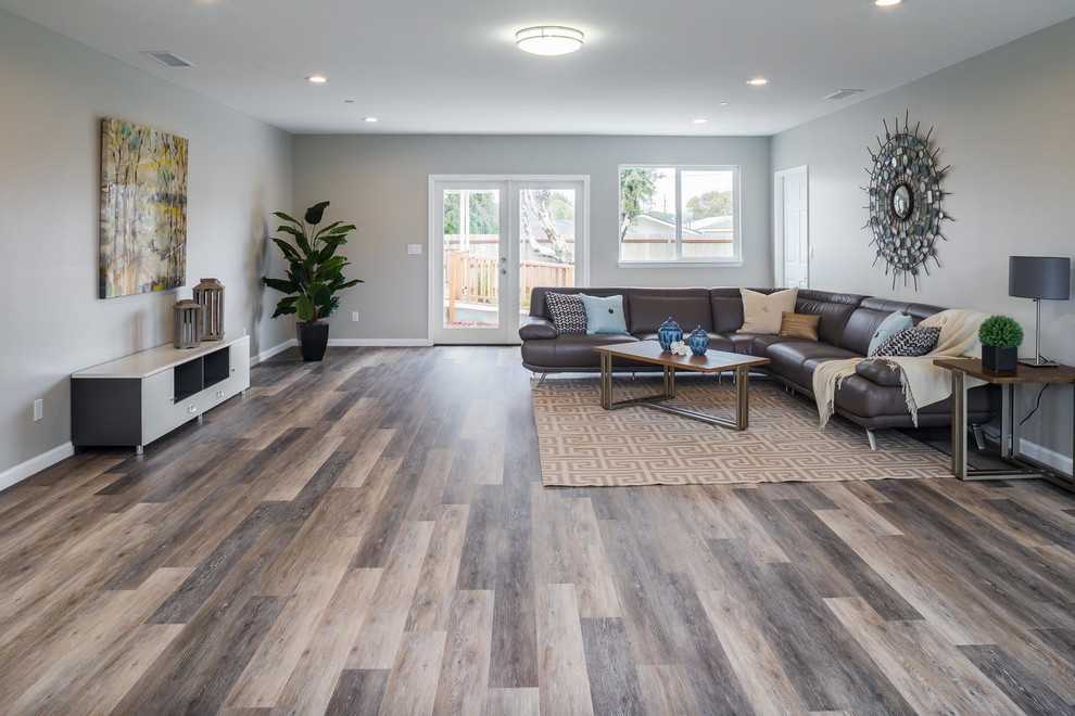 Inspiration for a large contemporary open concept living room in San Luis Obispo with grey walls, medium hardwood floors, no fireplace, no tv and brown floor.