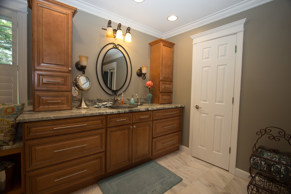 This is an example of a large transitional master bathroom in DC Metro with a drop-in sink, raised-panel cabinets, medium wood cabinets, granite benchtops, a curbless shower, white tile, ceramic tile and green walls.