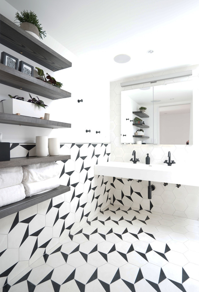 Mid-sized contemporary master bathroom in New York with black and white tile, cement tile, white walls, cement tiles, a trough sink and white floor.