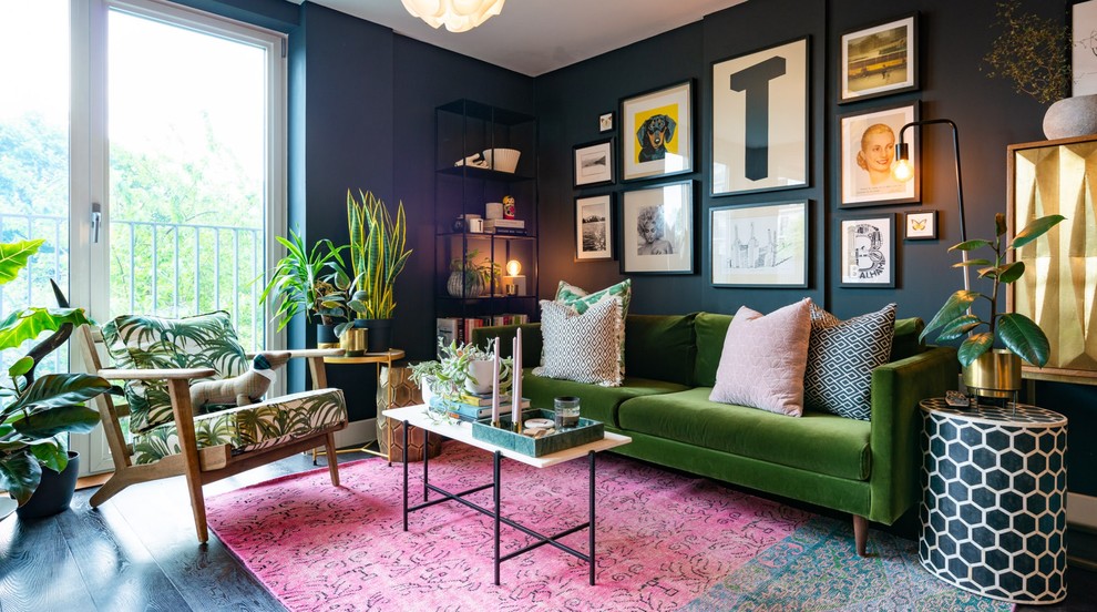 Design ideas for an eclectic living room in London with black walls, dark hardwood floors and black floor.
