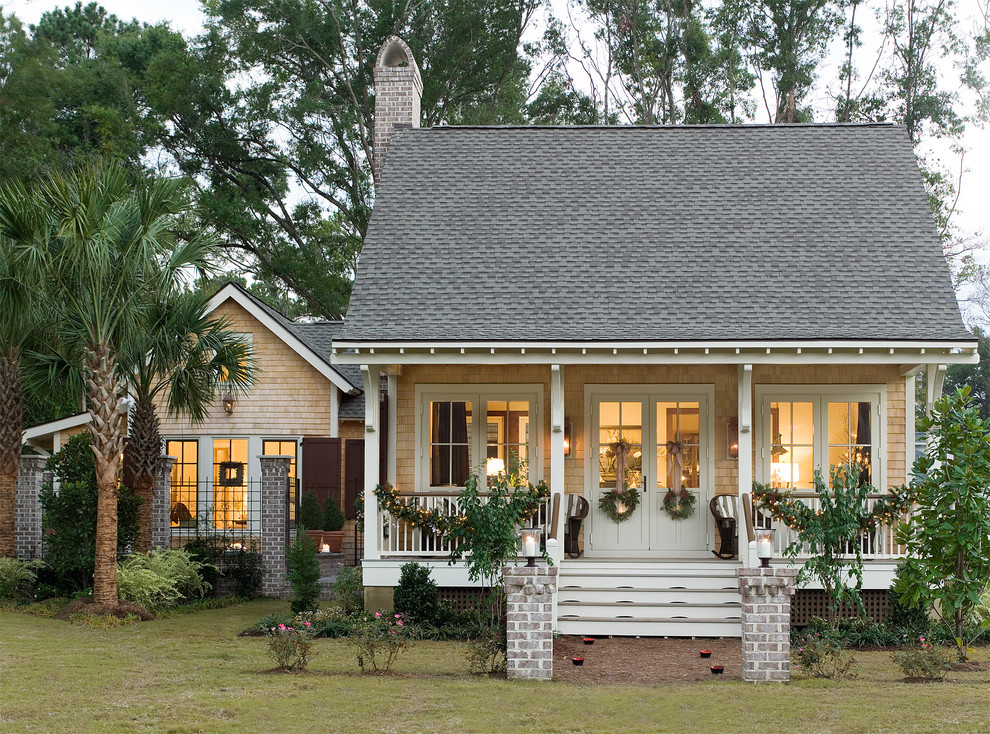 Photo of a mid-sized tropical two-storey exterior in Atlanta with wood siding.
