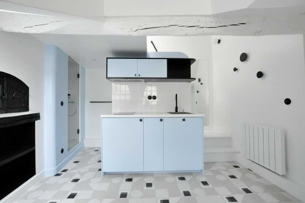 Inspiration för små moderna linjära vitt kök med öppen planlösning, med en enkel diskho, luckor med profilerade fronter, blå skåp, laminatbänkskiva, vitt stänkskydd, stänkskydd i keramik, klinkergolv i keramik och flerfärgat golv