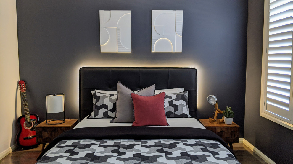 This is an example of a small contemporary bedroom in Sydney with grey walls, laminate floors and grey floor.