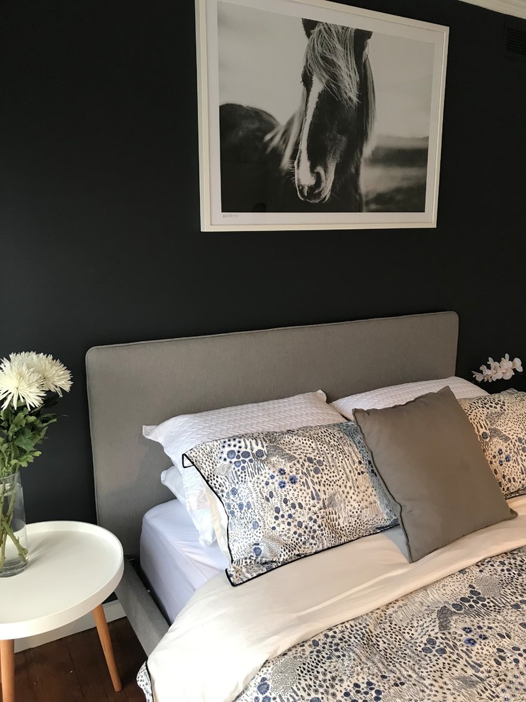 Eclectic guest bedroom in Melbourne with grey walls and dark hardwood floors.