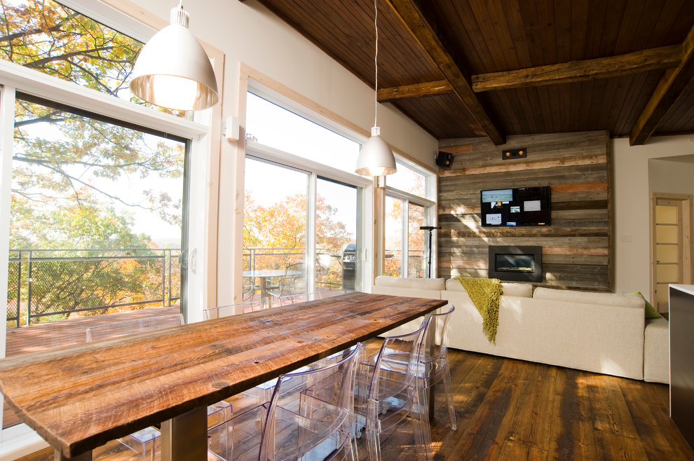 This is an example of a contemporary open plan dining in Montreal with white walls and dark hardwood floors.