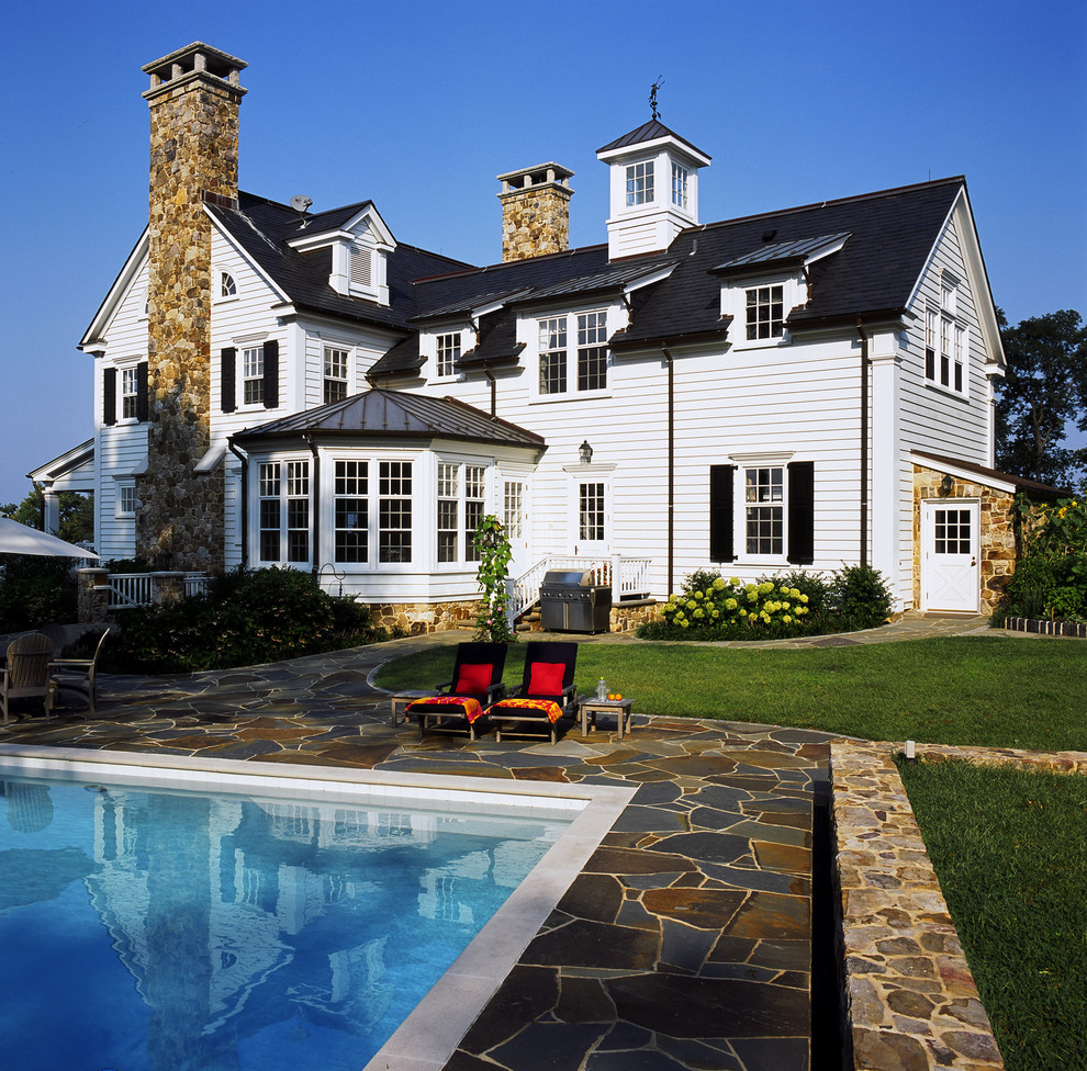 Inspiration for a traditional exterior in Baltimore with stone veneer and a mixed roof.